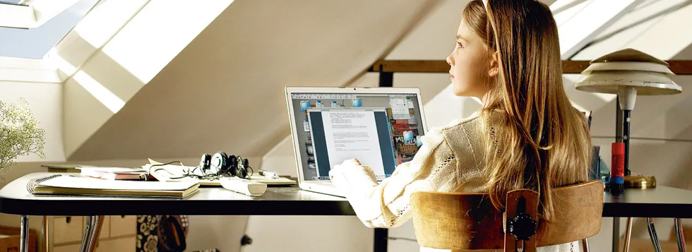 Girl on laptop in loft conversion