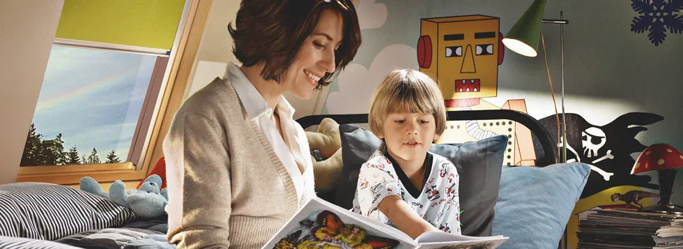Mum and son reading book in loft conversion